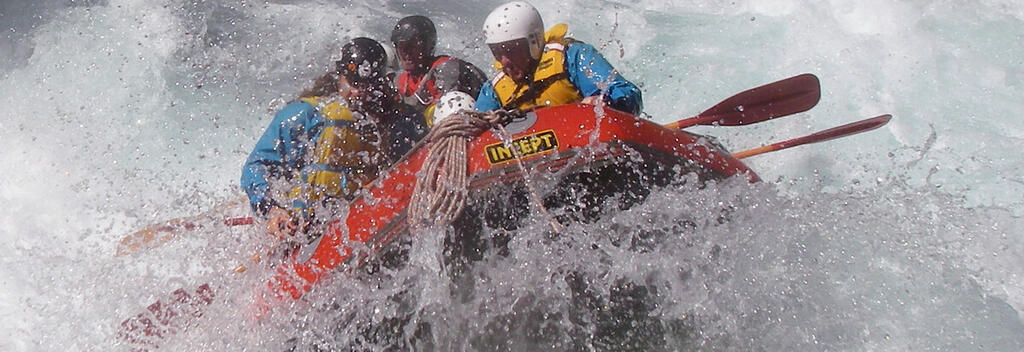People white water rafting on a river
