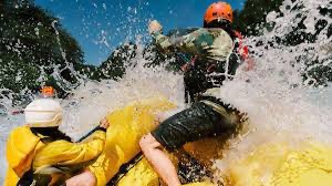 People white water rafting on a river